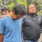 DBM (kaos biru) terduga pelaku pembunuhan keji terhadap Ibu dan Anak di Madiun ketika diamankan Ditreskrimum Polda Jatim. Foto/Ist